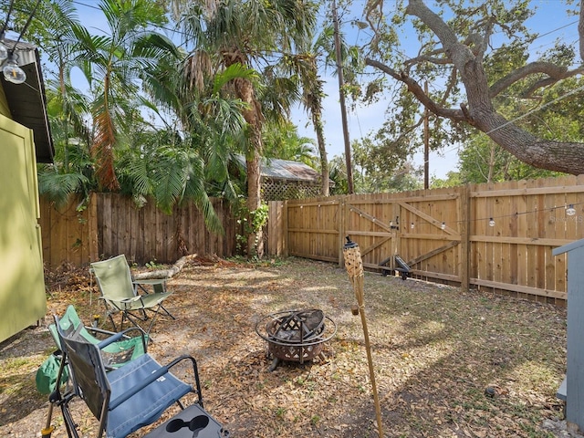 view of yard with an outdoor fire pit