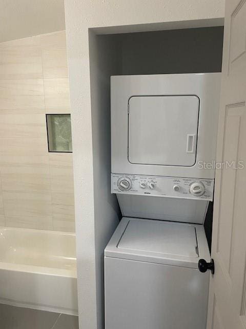 laundry area featuring stacked washer and clothes dryer