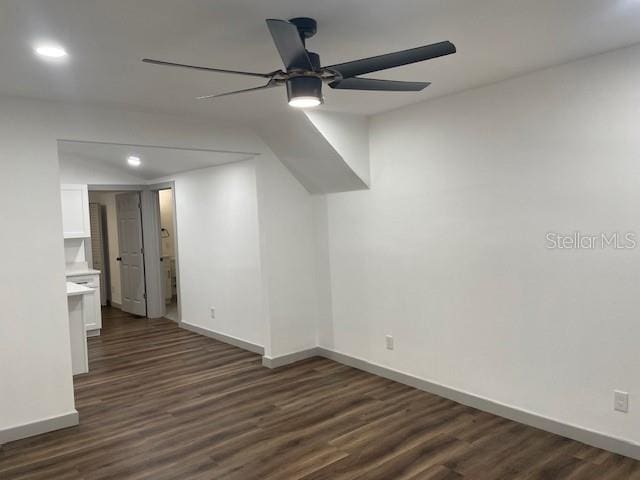 empty room featuring dark wood-type flooring and ceiling fan