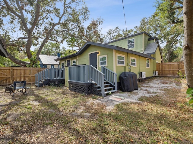 back of house with a deck