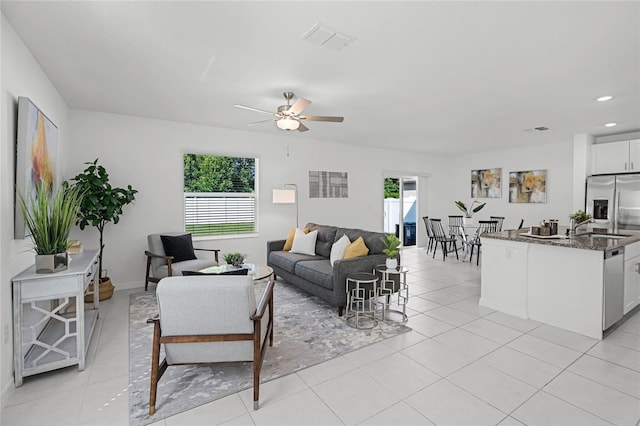 tiled living room featuring ceiling fan