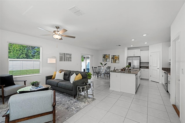 living room featuring ceiling fan and light tile patterned flooring