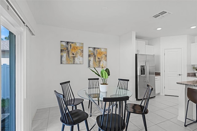 dining space featuring light tile patterned floors