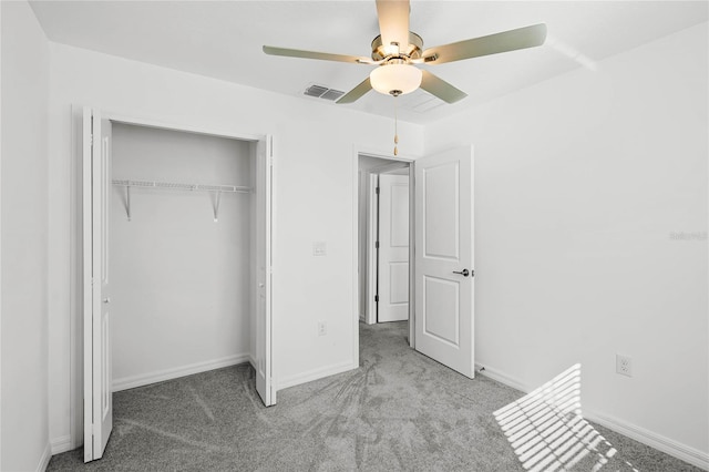 unfurnished bedroom with ceiling fan, light colored carpet, and a closet