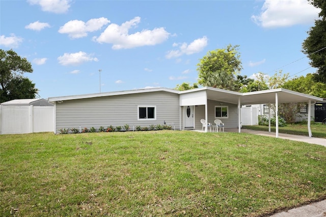 view of front facade with a carport and a front yard