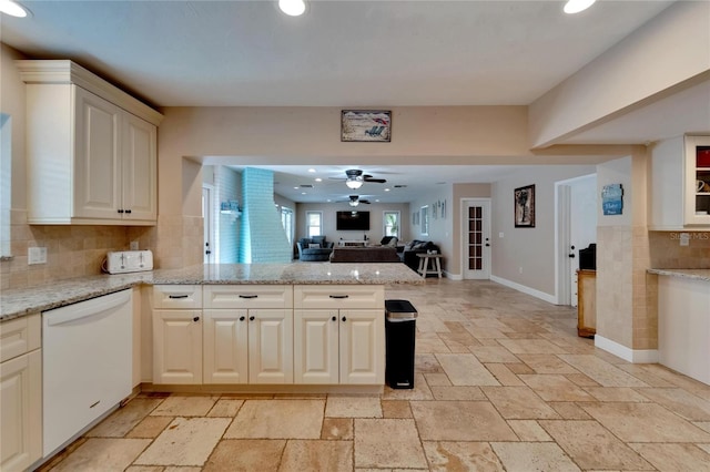 kitchen with decorative backsplash, ceiling fan, white dishwasher, and light stone countertops