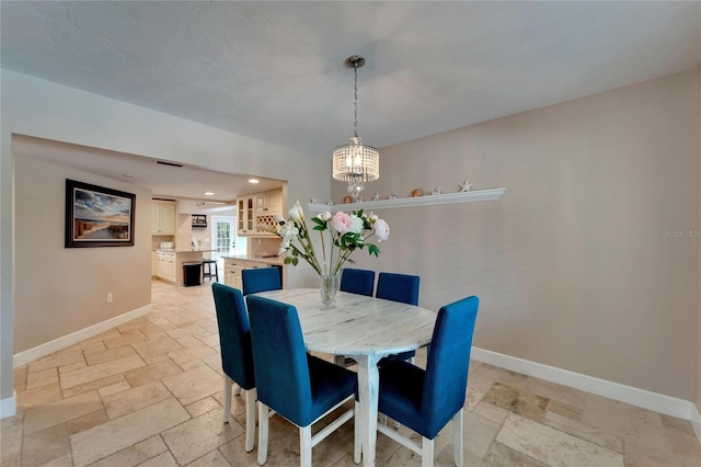 dining space with an inviting chandelier