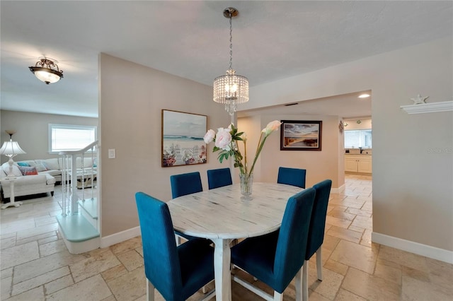 dining space featuring a notable chandelier