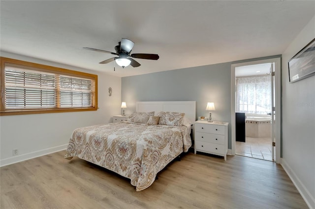 bedroom with light hardwood / wood-style flooring, connected bathroom, and ceiling fan