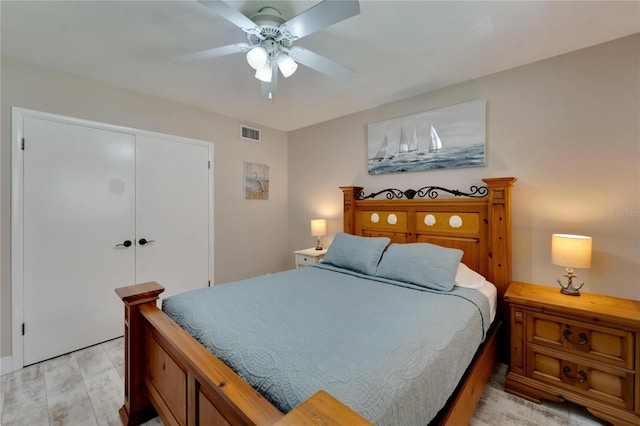 bedroom featuring ceiling fan, a closet, and light hardwood / wood-style floors