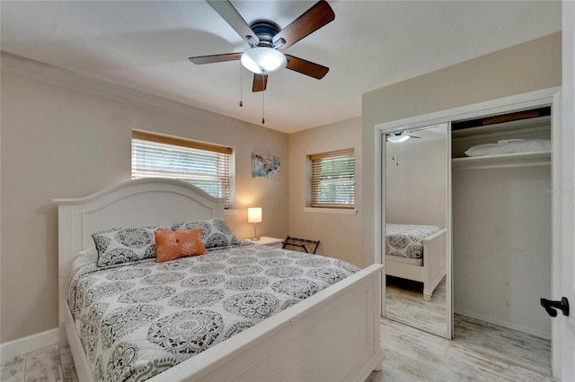 bedroom featuring light hardwood / wood-style floors, ceiling fan, and a closet