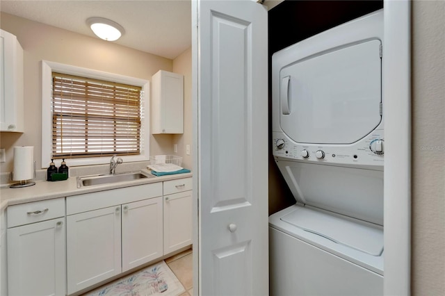 clothes washing area featuring stacked washer / drying machine and sink