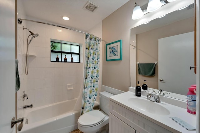 full bathroom with vanity, shower / tub combo, and toilet