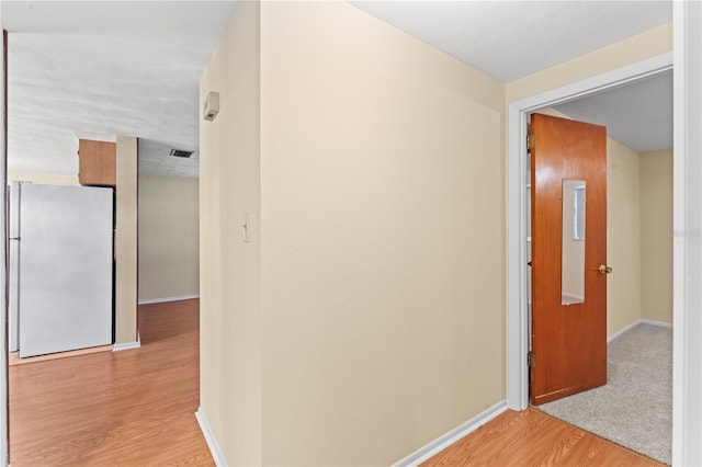 hall with light wood-type flooring