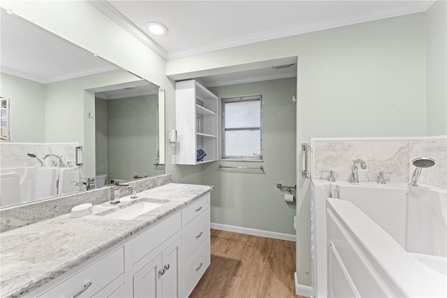 bathroom with vanity, a washtub, crown molding, hardwood / wood-style floors, and toilet