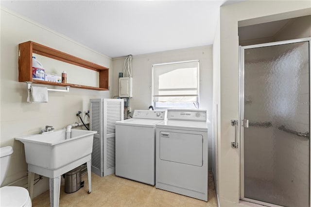 laundry area with crown molding and separate washer and dryer