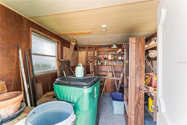 interior space with wooden walls and concrete floors