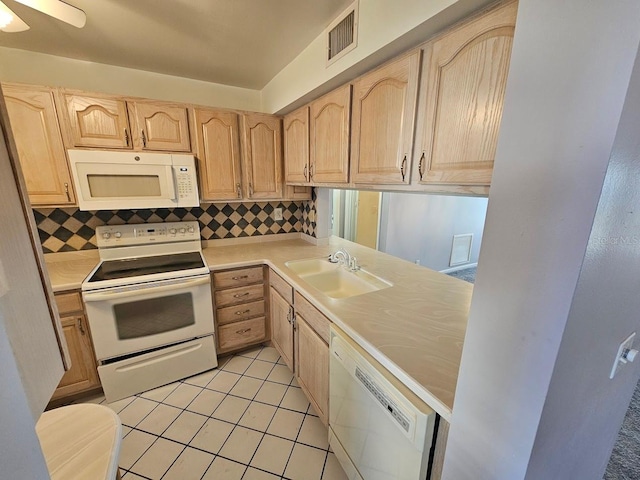 kitchen featuring light brown cabinets, decorative backsplash, light tile patterned floors, sink, and white appliances