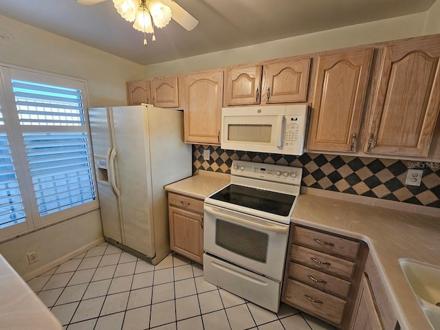 kitchen featuring white appliances, tasteful backsplash, ceiling fan, light tile patterned floors, and light brown cabinets