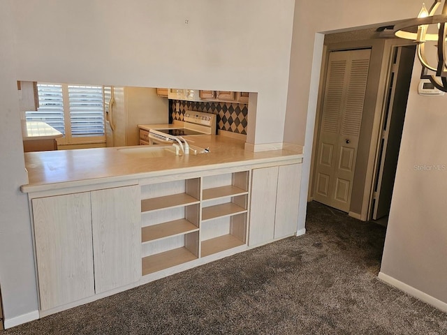 kitchen with light brown cabinetry, white electric range oven, sink, and dark carpet