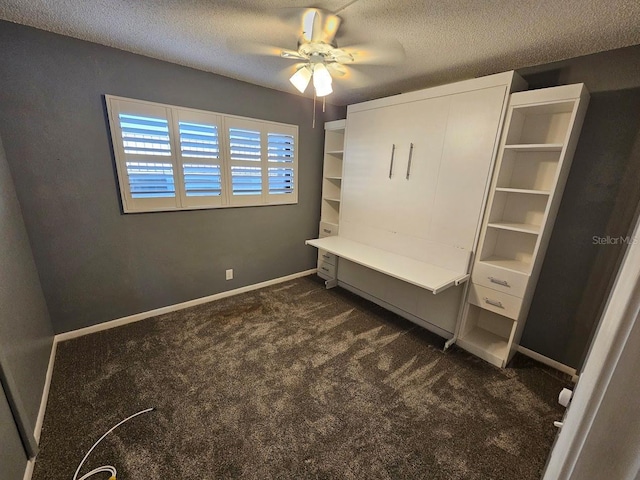 unfurnished bedroom with dark colored carpet, a textured ceiling, and ceiling fan