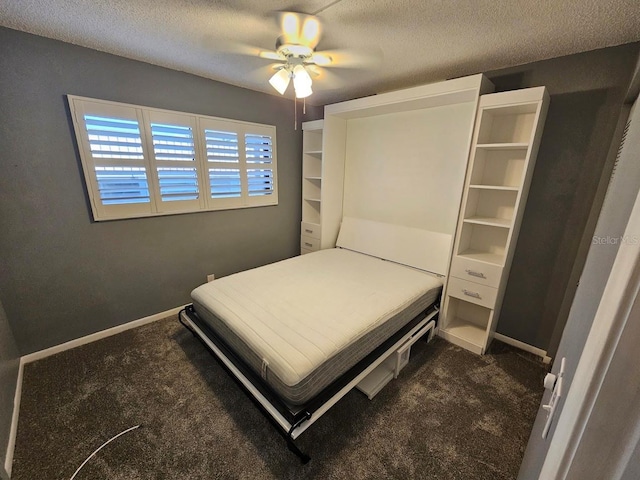 carpeted bedroom with ceiling fan and a textured ceiling