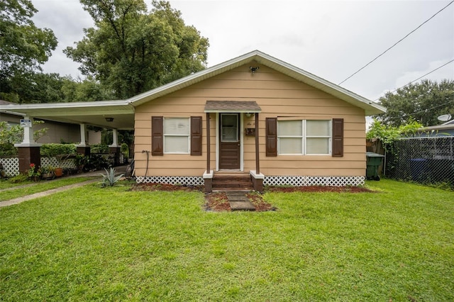 bungalow-style house featuring a carport and a front yard