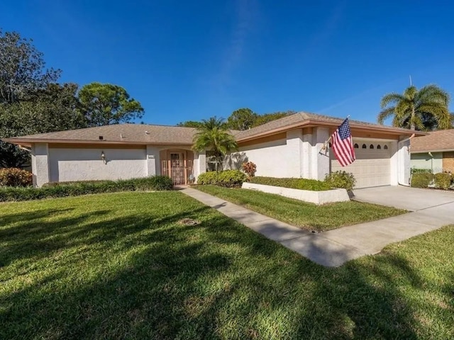 ranch-style home with a front yard and a garage