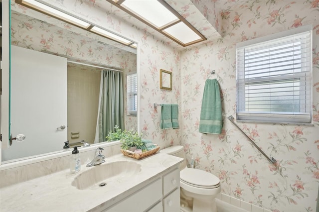 bathroom featuring toilet and vanity