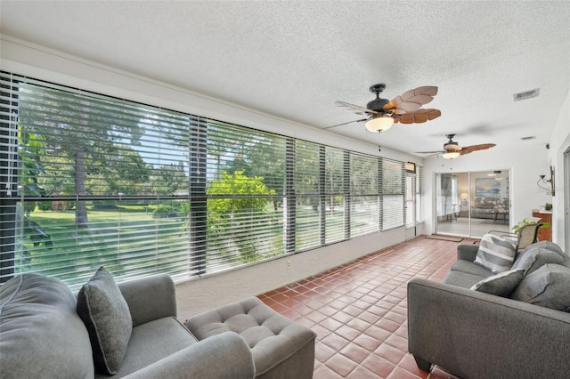 sunroom featuring ceiling fan