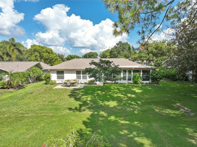 back of property featuring a patio area, a sunroom, and a yard