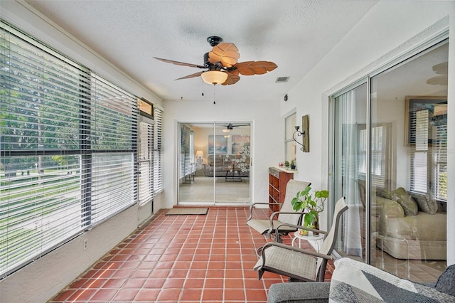 sunroom with ceiling fan and a healthy amount of sunlight