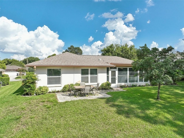 back of property featuring a patio and a yard