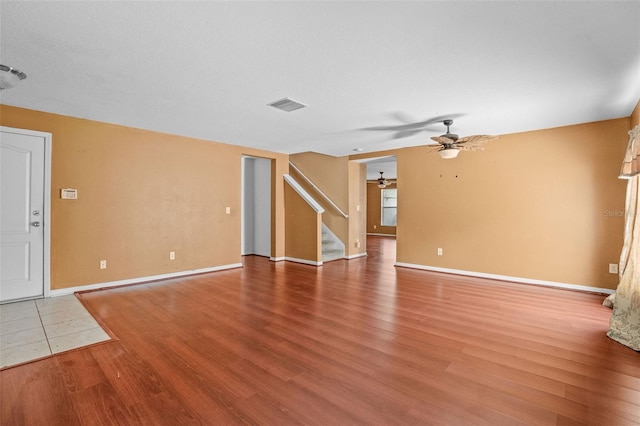 interior space featuring ceiling fan, hardwood / wood-style floors, and a textured ceiling