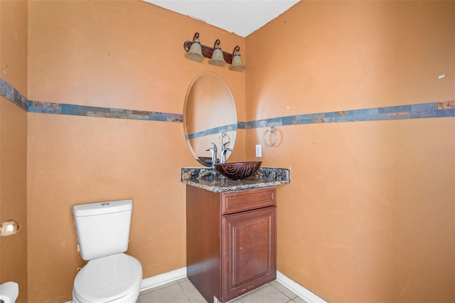 bathroom featuring vanity, tile patterned flooring, and toilet