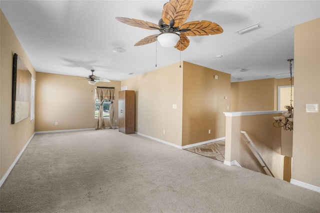 spare room featuring light carpet and ceiling fan