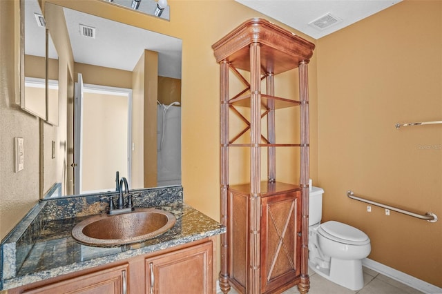 bathroom with vanity, tile patterned flooring, and toilet