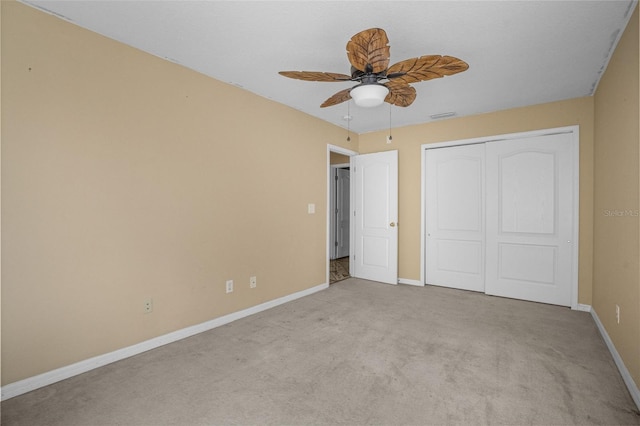 unfurnished bedroom featuring light carpet, a closet, and ceiling fan