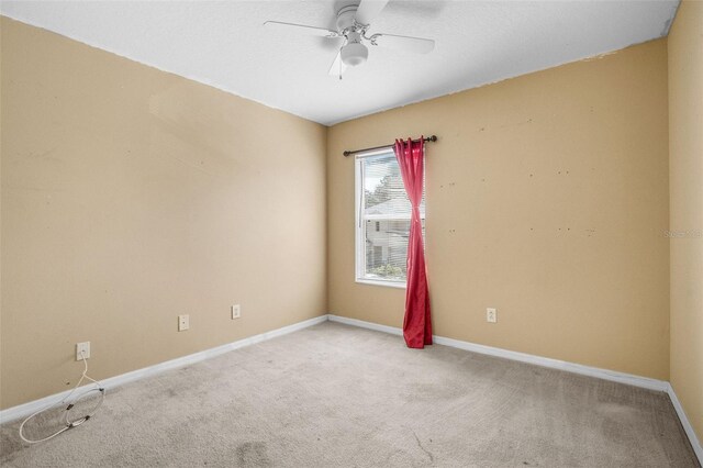 unfurnished room with ceiling fan and light colored carpet