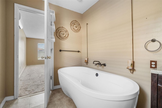 bathroom featuring vanity, a tub to relax in, and tile patterned floors