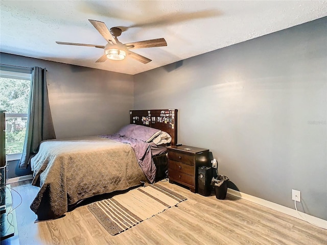 bedroom featuring ceiling fan and light hardwood / wood-style floors