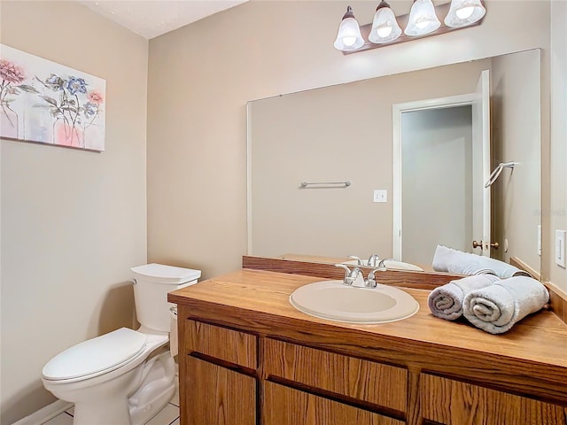 bathroom with vanity, toilet, and tile patterned floors