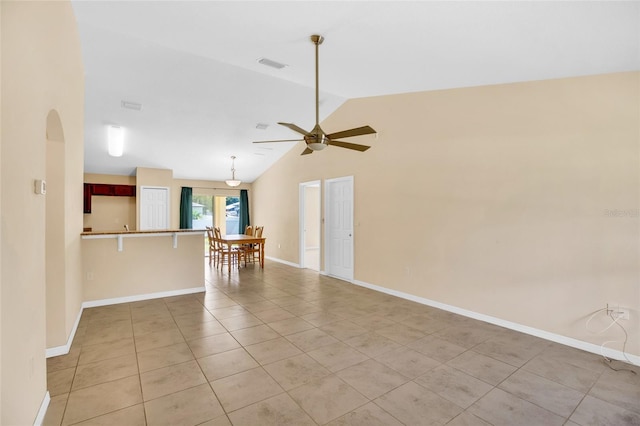 tiled empty room featuring high vaulted ceiling and ceiling fan