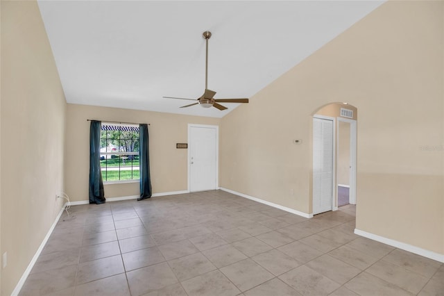 spare room featuring vaulted ceiling, ceiling fan, and light tile patterned floors