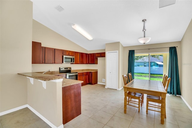 kitchen with pendant lighting, lofted ceiling, light tile patterned floors, kitchen peninsula, and appliances with stainless steel finishes