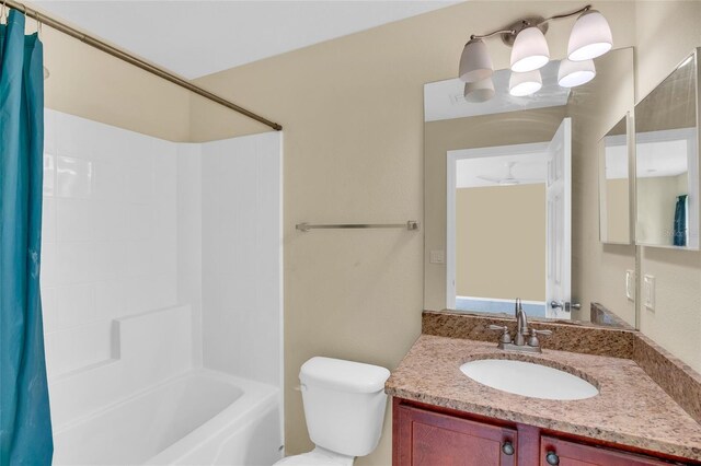 full bathroom with shower / bath combo with shower curtain, vanity, and toilet