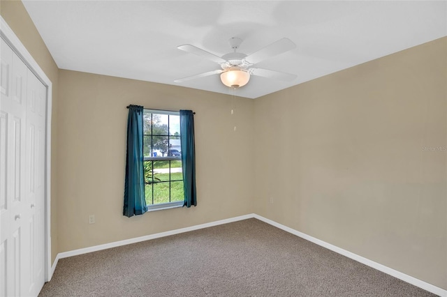 unfurnished bedroom with ceiling fan, a closet, and carpet flooring