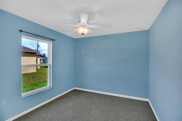 carpeted empty room with ceiling fan