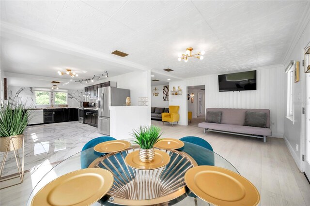 interior space featuring ornamental molding and light hardwood / wood-style flooring