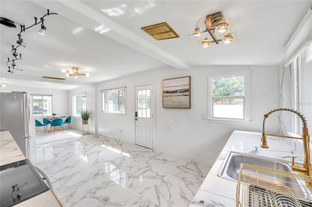 entryway featuring vaulted ceiling with beams and sink